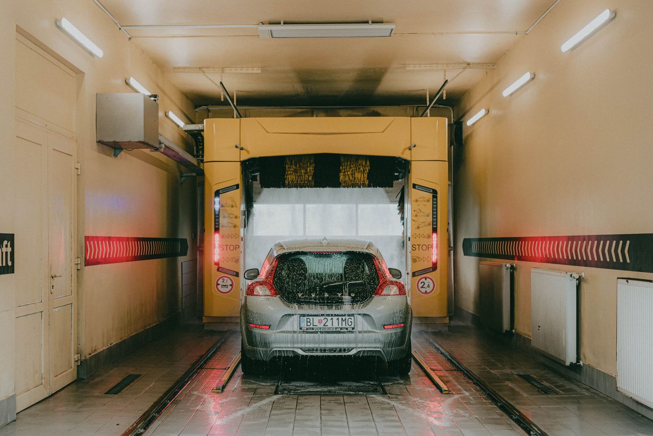 Vehicle inside a brightly lit automatic wash tunnel