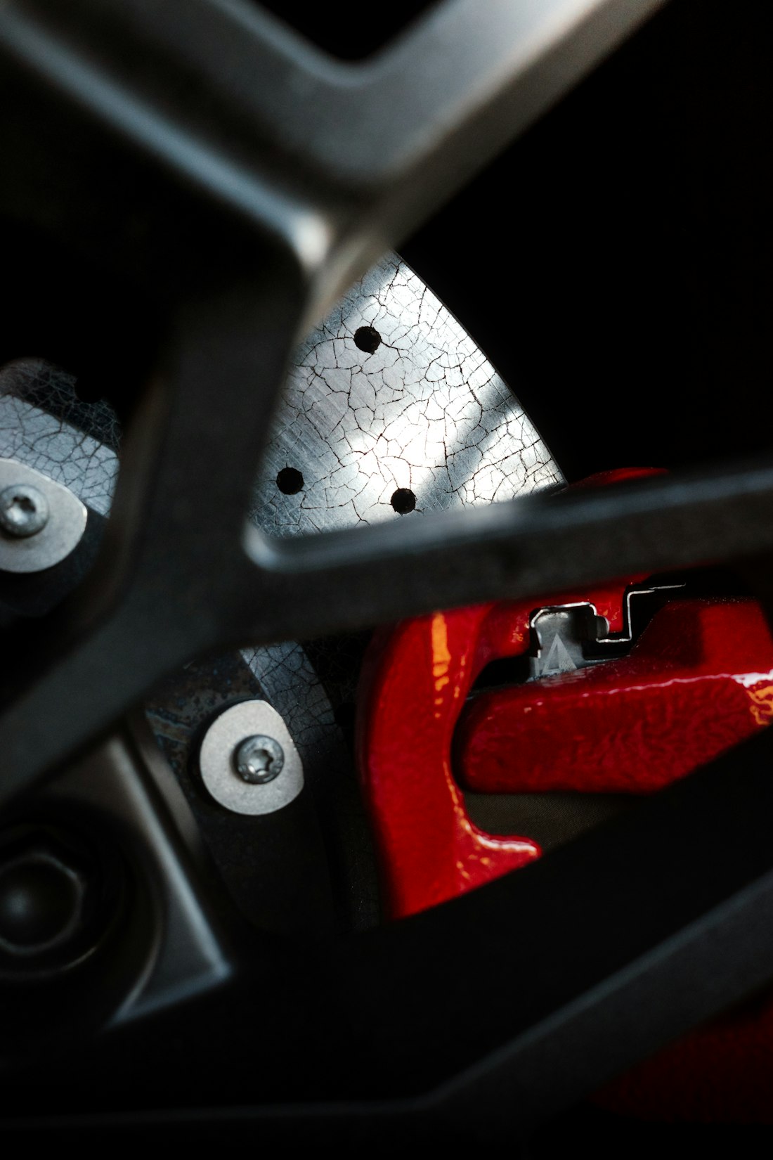 Close-up of a red brake caliper and rotor