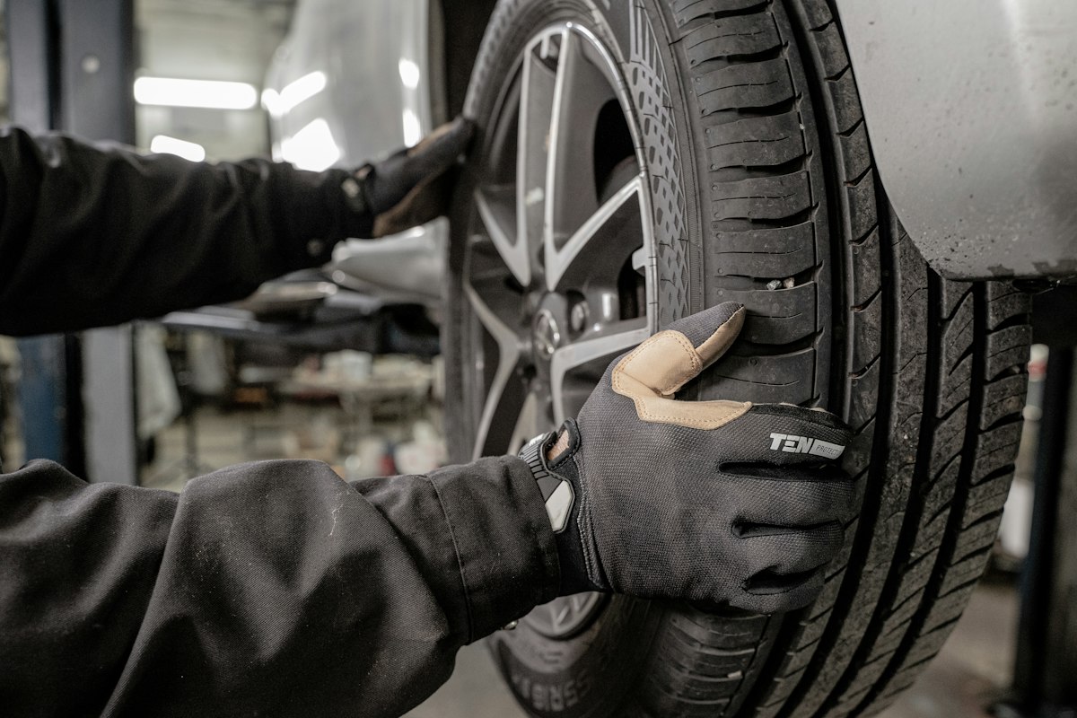 Technician servicing a tyre in a garage